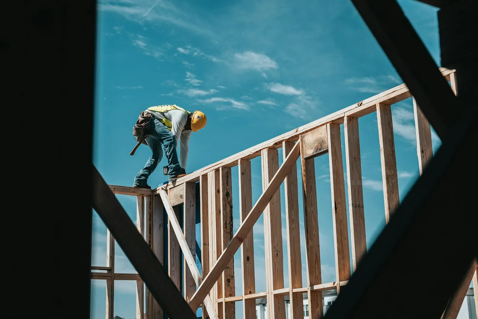 A skilled tradesperson on a building frame